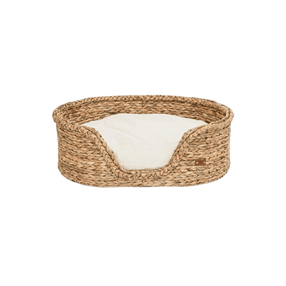 Front view of Pet & Co.’s rattan dog bed with cream cushion, offering comfort and rustic charm for your pet. Frontansicht des Rattan-Hundebetts von Pet & Co. mit cremefarbenem Kissen, bietet Komfort und rustikalen Charme für Ihren Hund. Vue de face du panier pour chien en rotin de Pet & Co. avec coussin crème, pour un confort et un charme rustique.