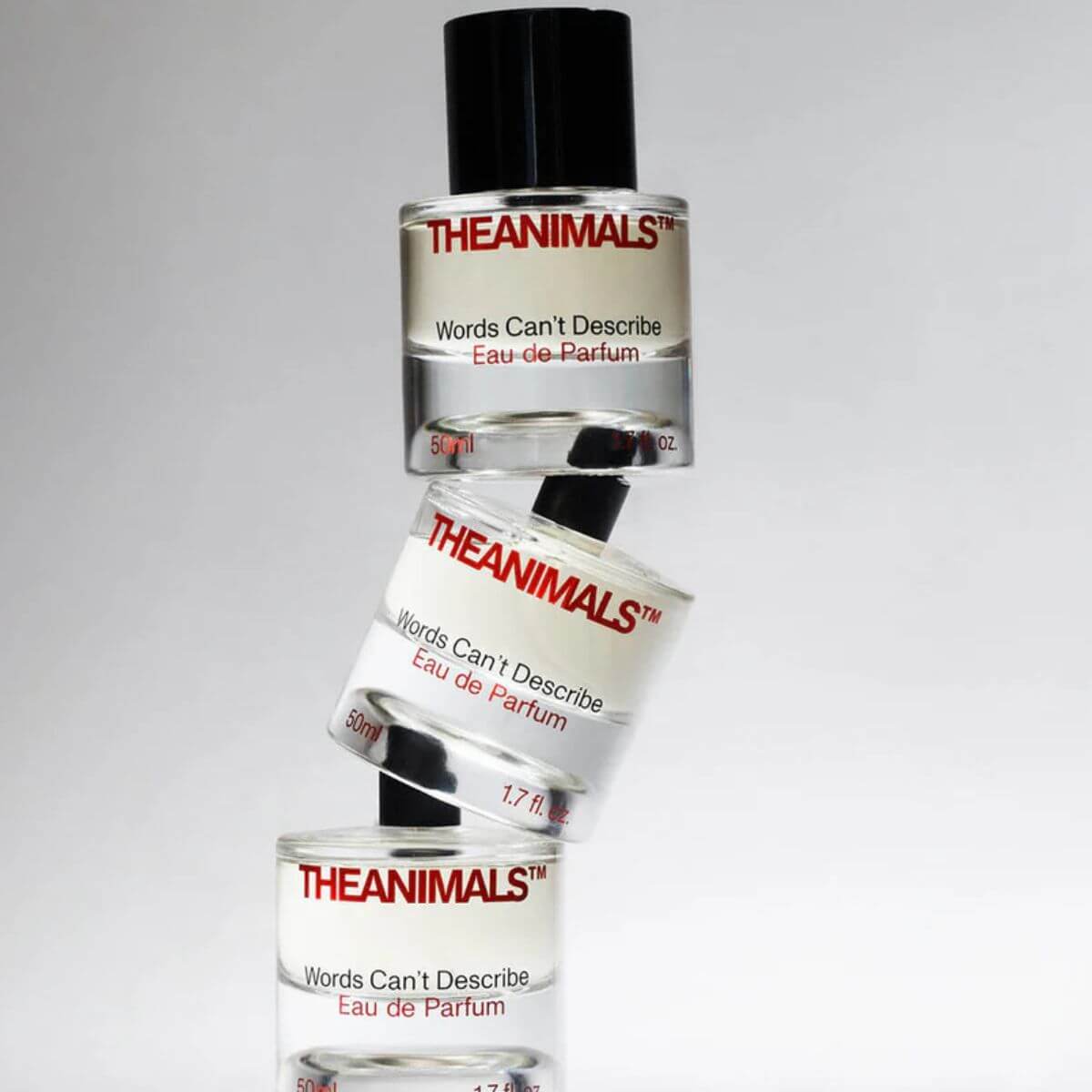 The Animals "Words Can't Describe" perfume bottles stacked. Bold scent with bergamot, saffron, rose, and woods. Gestapelte Flakons von The Animals „Words Can't Describe“. Duft mit Bergamotte, Safran, Rose und Hölzern. Flacons empilés de "Words Can't Describe" par The Animals. Parfum à la bergamote, safran, rose et bois.